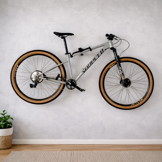 Silver-colored bike wall mounting system with a mountain bike stored horizontally in a living room.