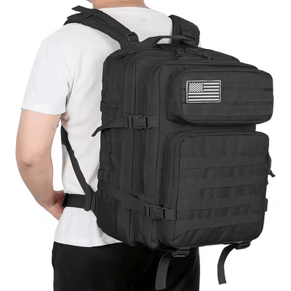 Green backpack with multiple compartments and straps, photographed from the front at an angle.